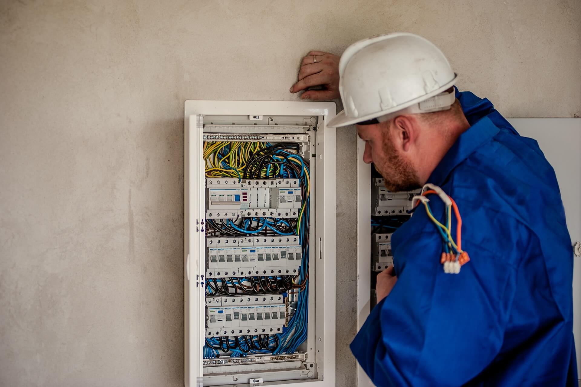 picture of a man inspecting an electrical panel Fort Worth TX